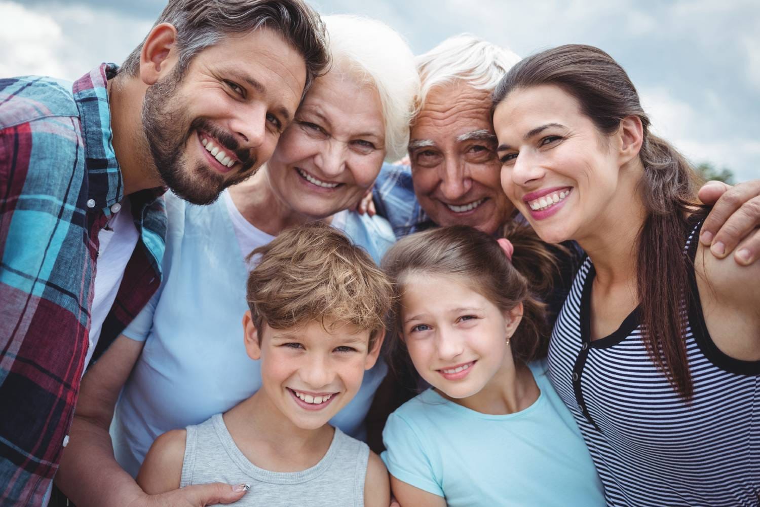 Happy multi-generation family standing outdoors